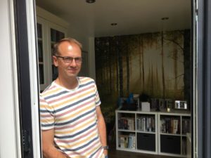 Nathan Dylan Goodwin in front of his writing space